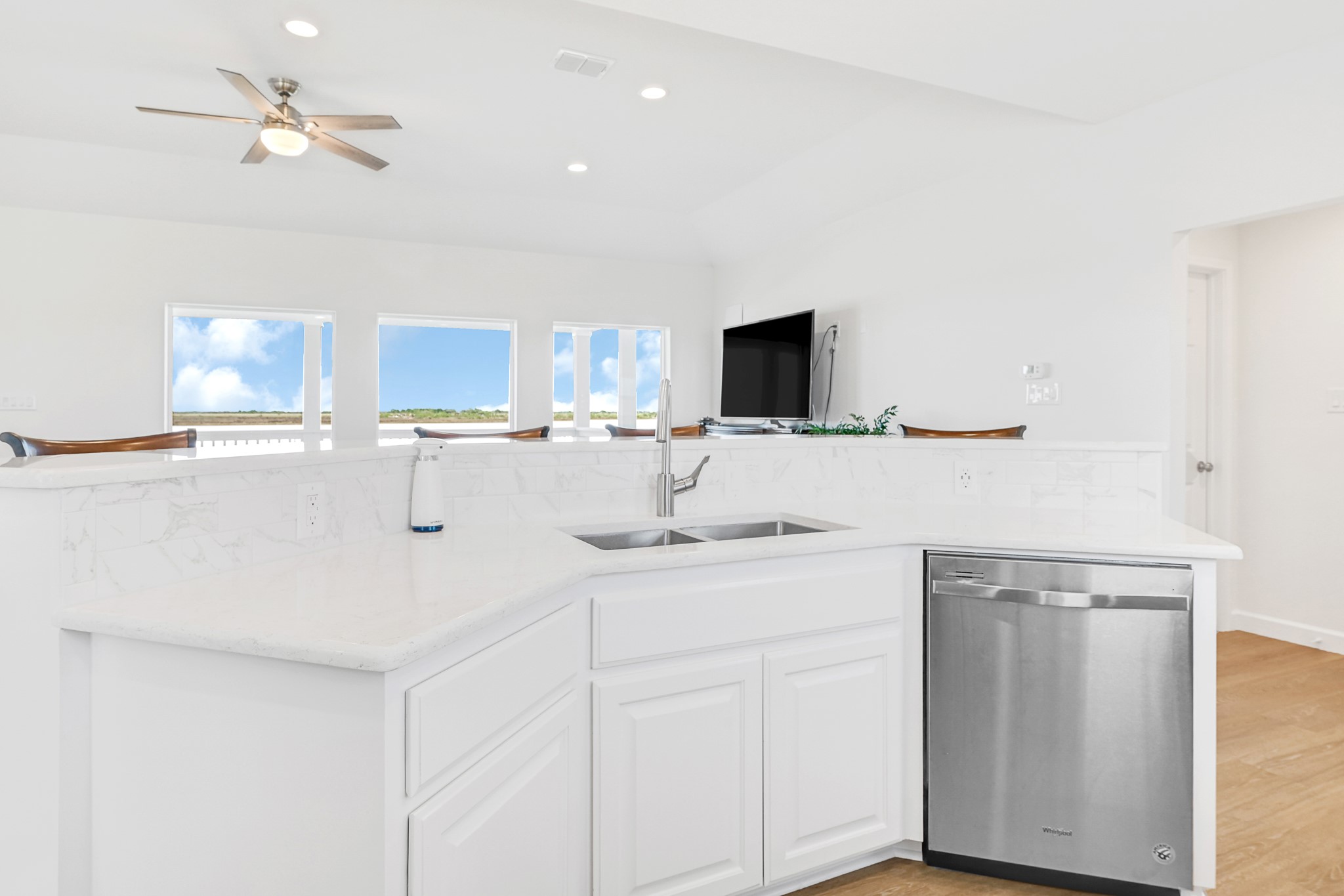 747 Waypoint Drive Palacios, TX 77465 - Photo 20 of 45 a kitchen with stainless steel appliances a sink a stove a microwave a dining table and chairs