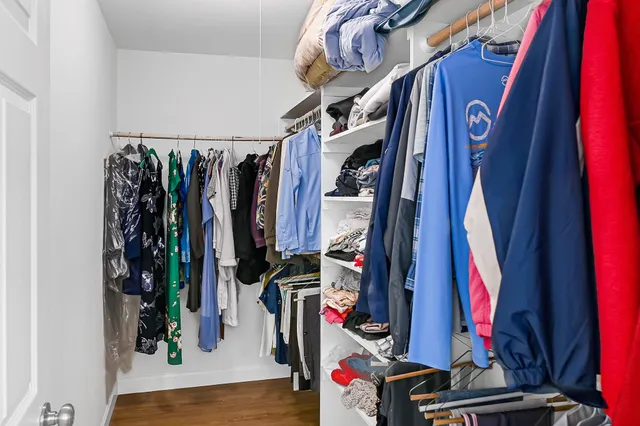 a view of walk in closet with clothes