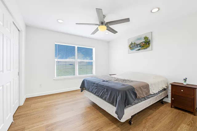 a large bed sitting in a bedroom next to a window