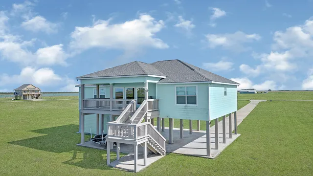 a front view of a house with a yard table and chairs