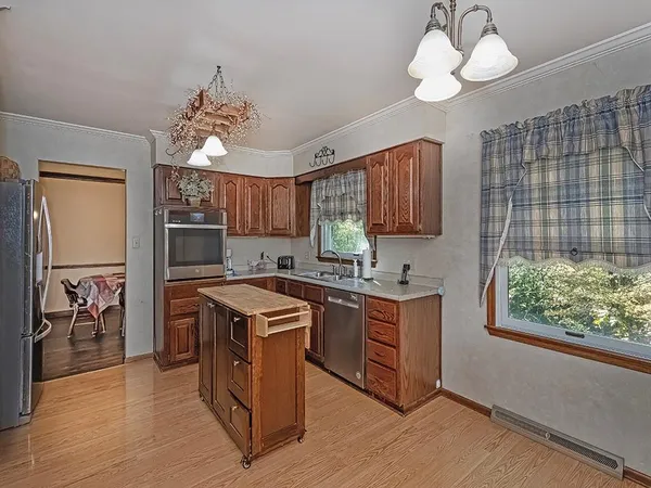 a kitchen with stainless steel appliances granite countertop a stove and a refrigerator