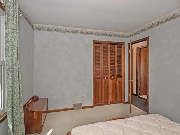 a bedroom with a bed and a dresser