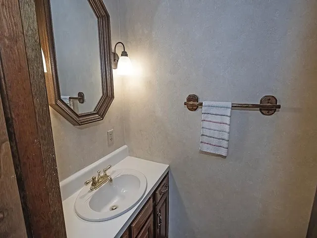 a bathroom with a sink a mirror and vanity