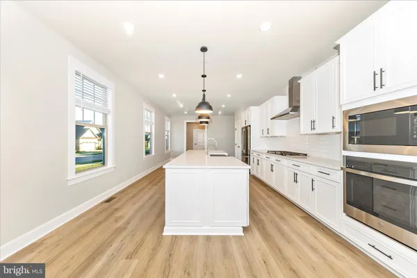 a kitchen with stainless steel appliances white cabinets and a stove