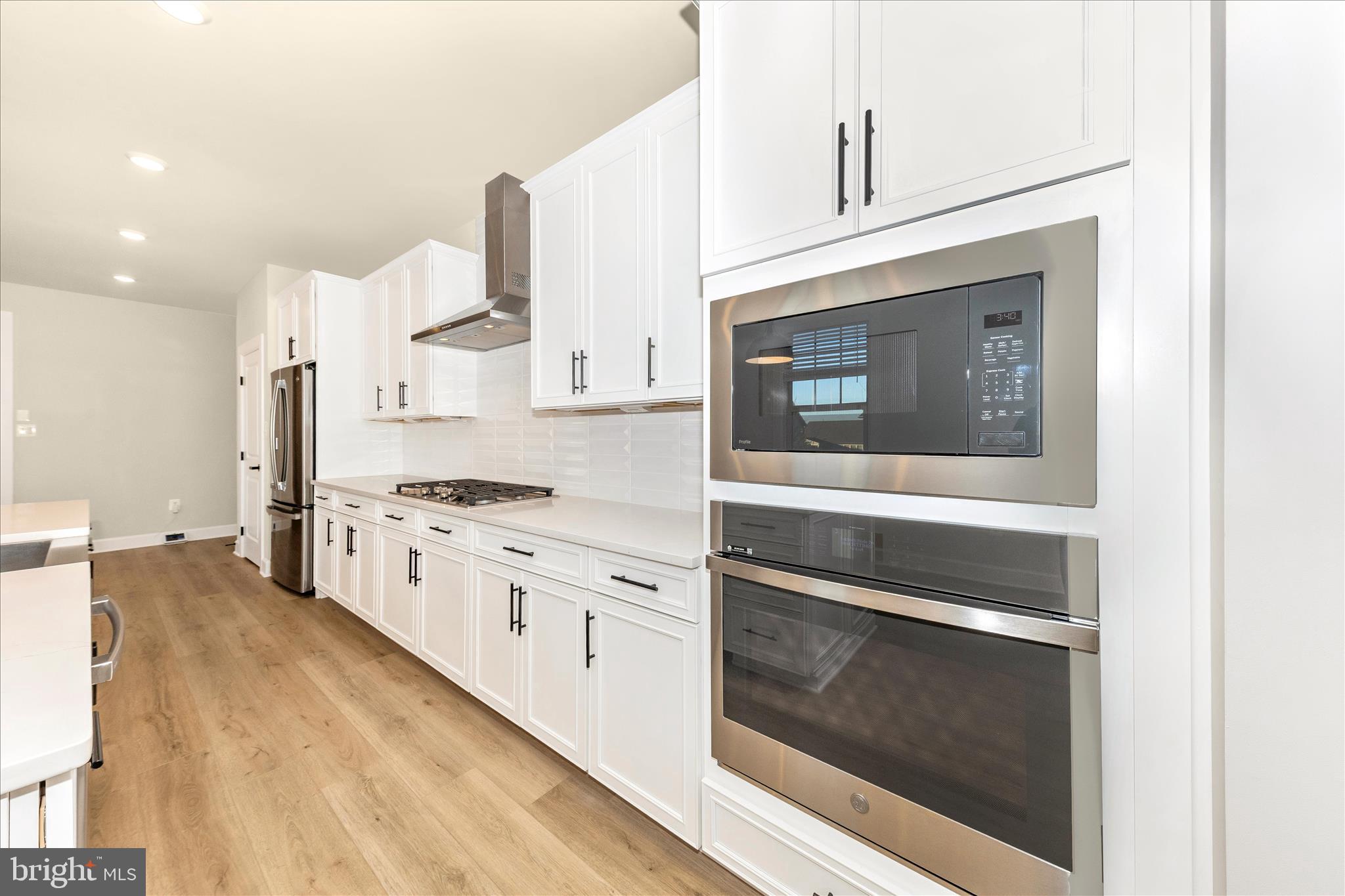 413 Bucklebury Lane Frederick, MD 21702 - Photo 12 of 58 a kitchen with stainless steel appliances white cabinets and a stove
