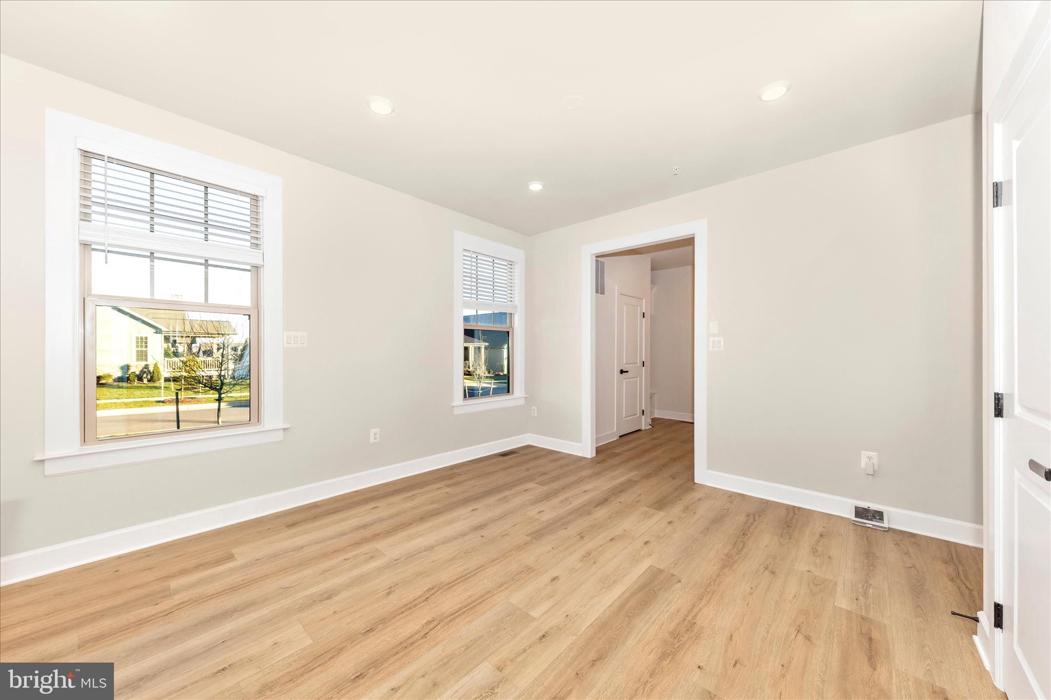 413 Bucklebury Lane Frederick, MD 21702 - Photo 18 of 58 an empty room with wooden floor and windows