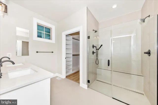a view of a hallway with wooden floor and closet