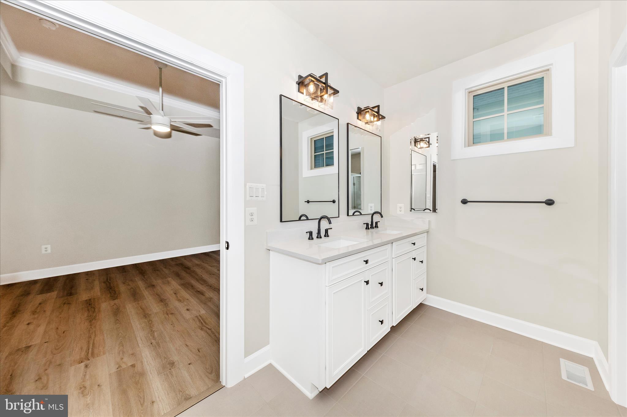 413 Bucklebury Lane Frederick, MD 21702 - Photo 26 of 58 a bathroom with a double vanity sink a mirror and shower