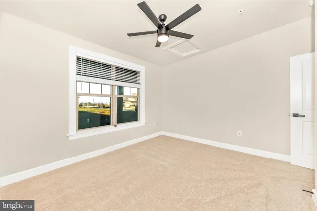 a view of a room with a ceiling fan