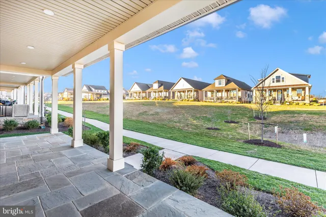 a view of an entrance to house with yard and green space