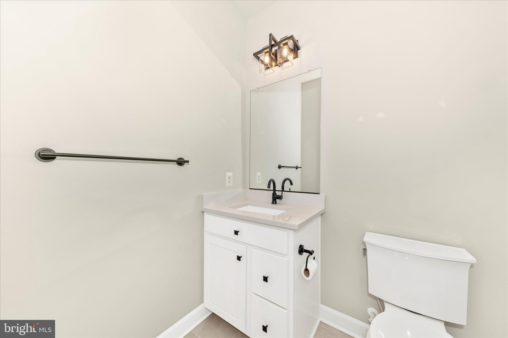 413 Bucklebury Lane Frederick, MD 21702 - Photo 33 of 58 a bathroom with a sink a toilet and mirror