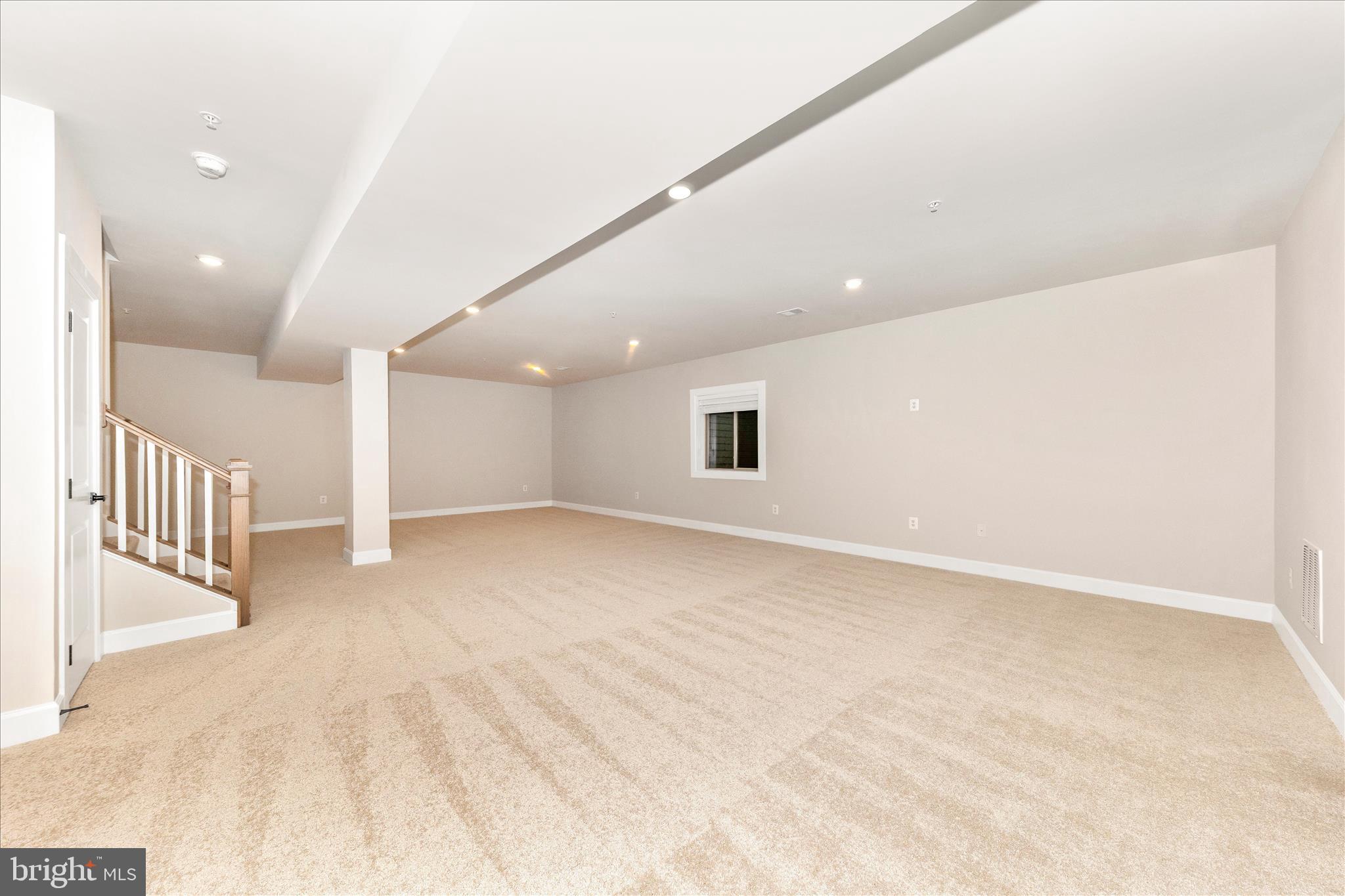 413 Bucklebury Lane Frederick, MD 21702 - Photo 42 of 58 an empty room with wooden floor and windows