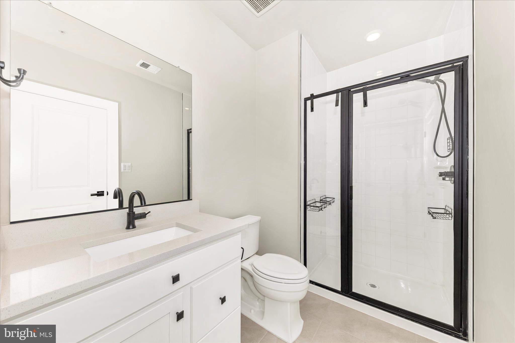 413 Bucklebury Lane Frederick, MD 21702 - Photo 46 of 58 a bathroom with a shower sink vanity mirror and toilet