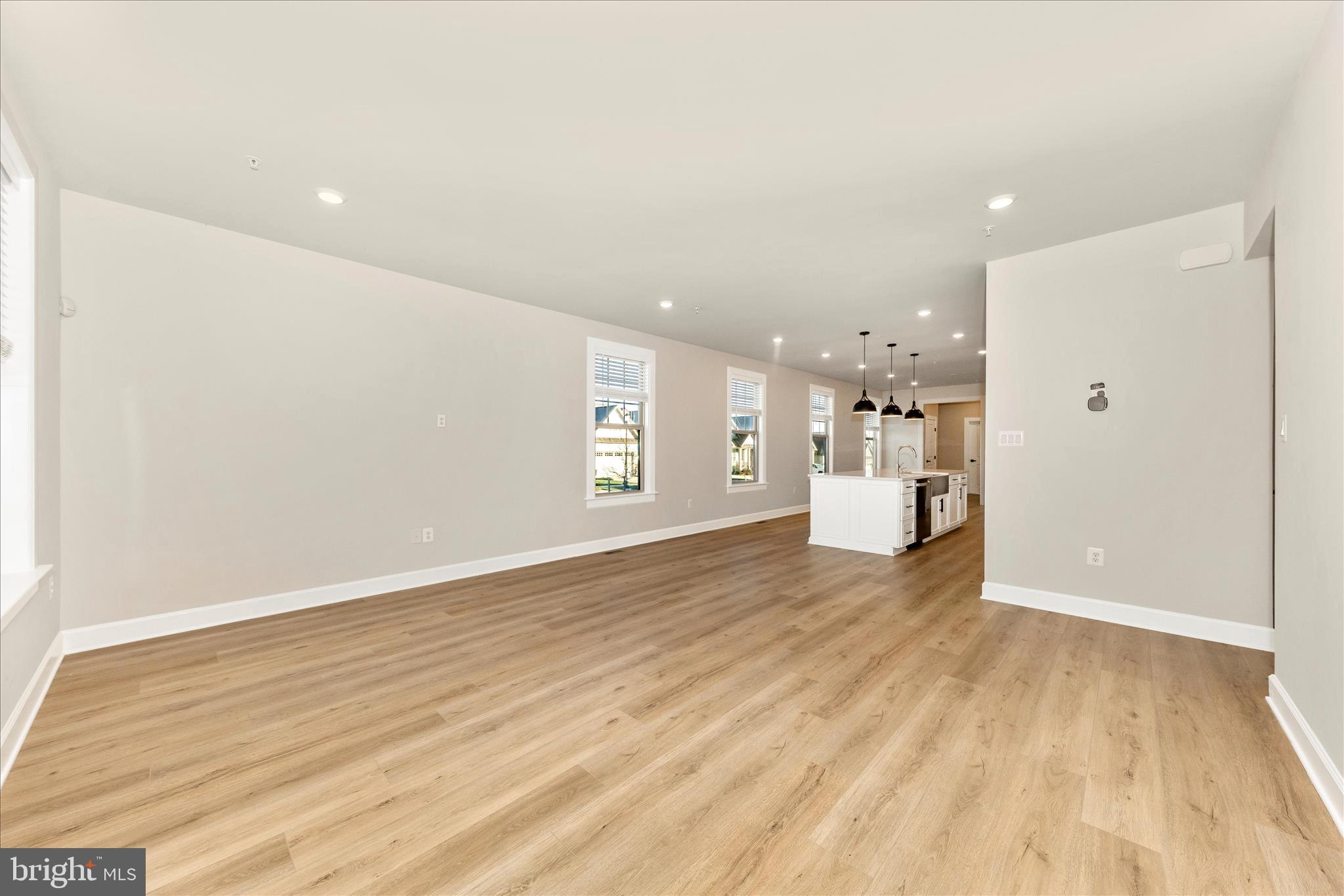 413 Bucklebury Lane Frederick, MD 21702 - Photo 7 of 58 a view of a big room with wooden floor and windows