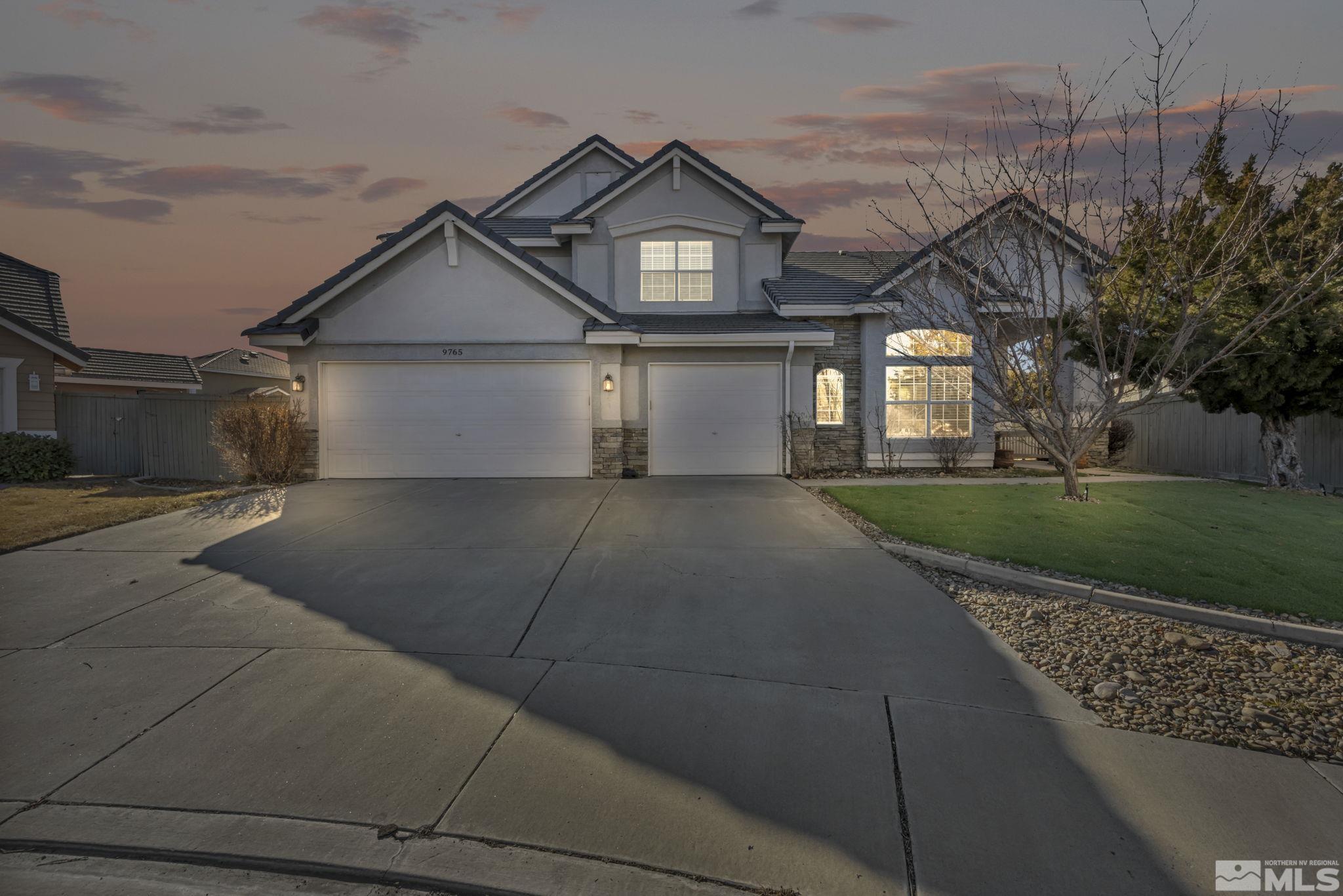 9765 Rolling Rock Court Reno, NV 89521 - Photo 1 of 39 a front view of a house with a yard and garage