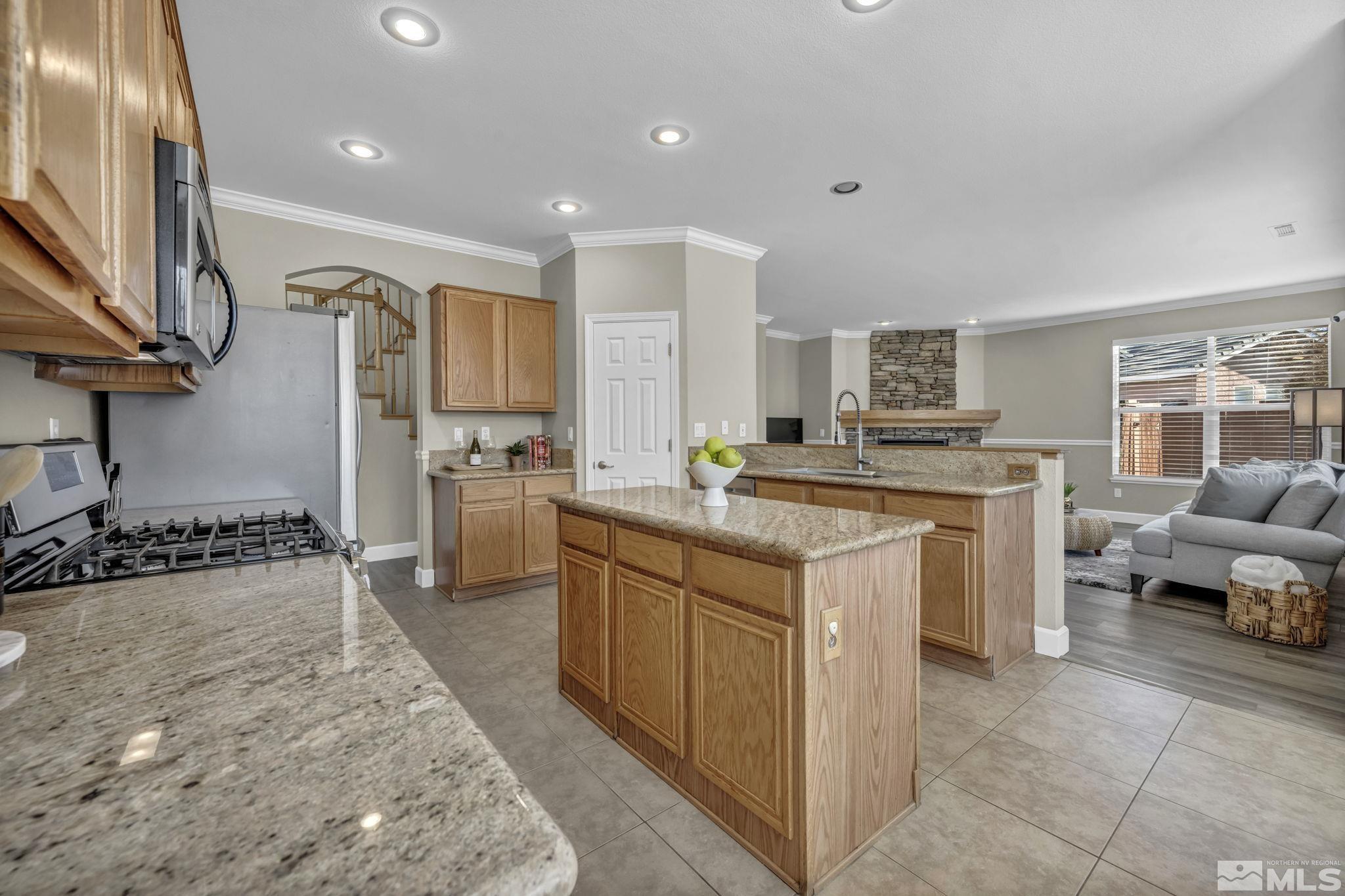 9765 Rolling Rock Court Reno, NV 89521 - Photo 11 of 39 a kitchen with a sink stove and cabinets