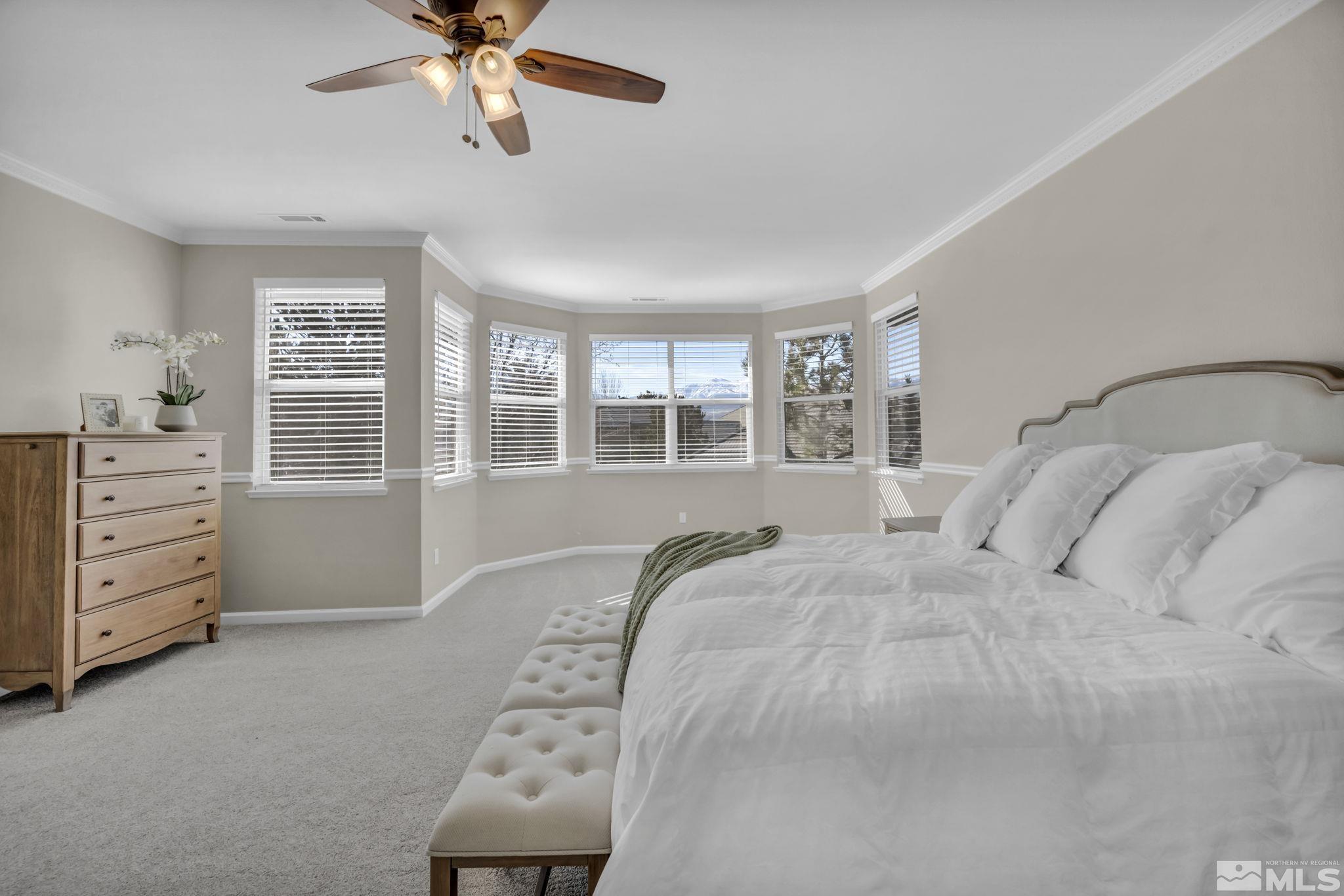 9765 Rolling Rock Court Reno, NV 89521 - Photo 19 of 39 a bedroom with a bed and a window