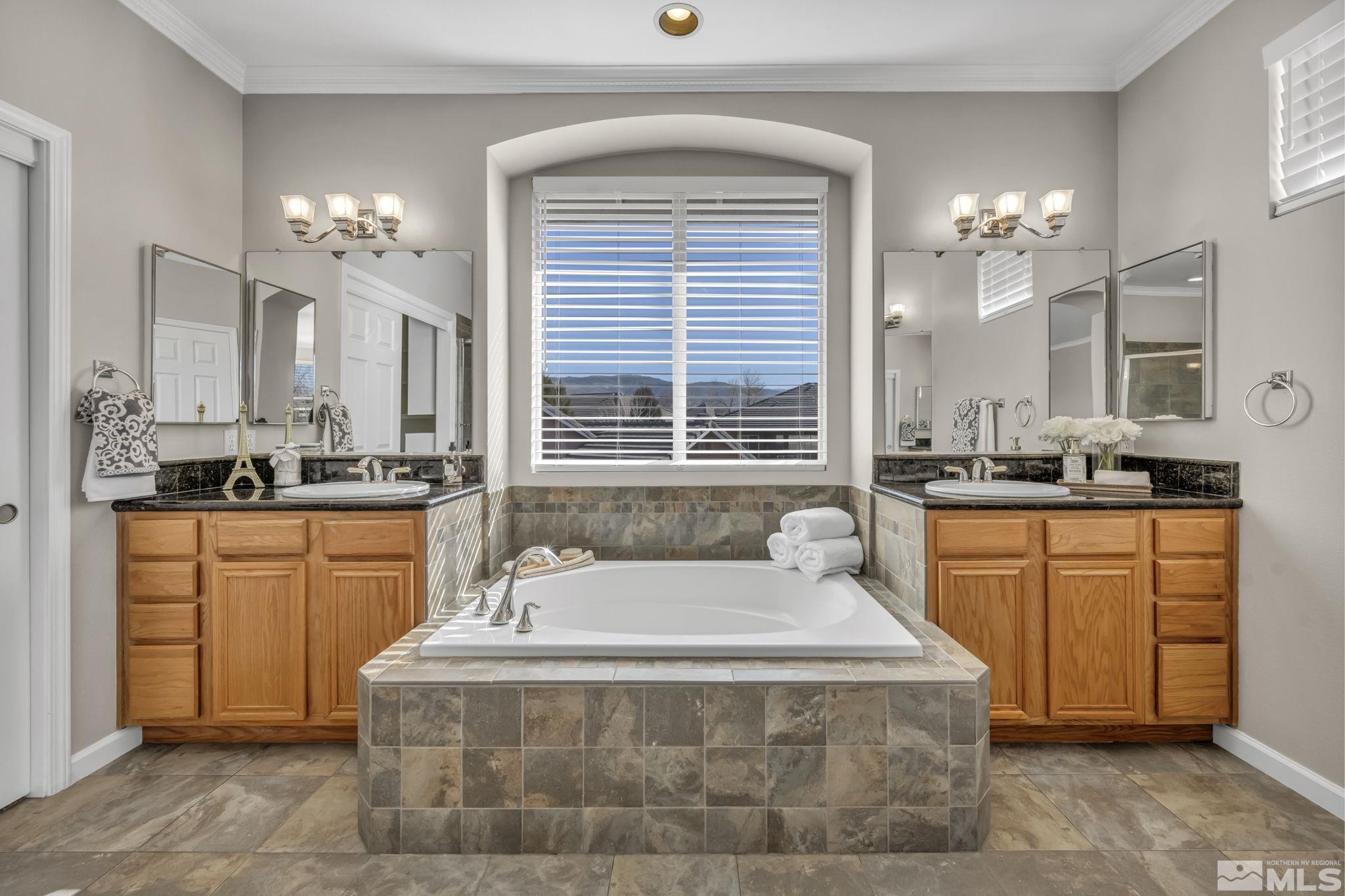 9765 Rolling Rock Court Reno, NV 89521 - Photo 20 of 39 a spacious bathroom with a granite countertop sink mirror and a bathtub