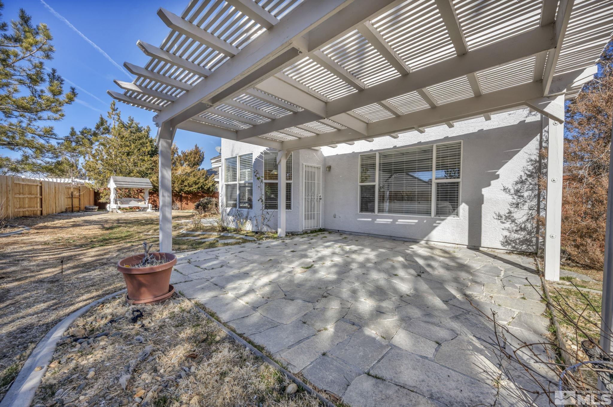 9765 Rolling Rock Court Reno, NV 89521 - Photo 28 of 39 a view of a porch with a table and chairs