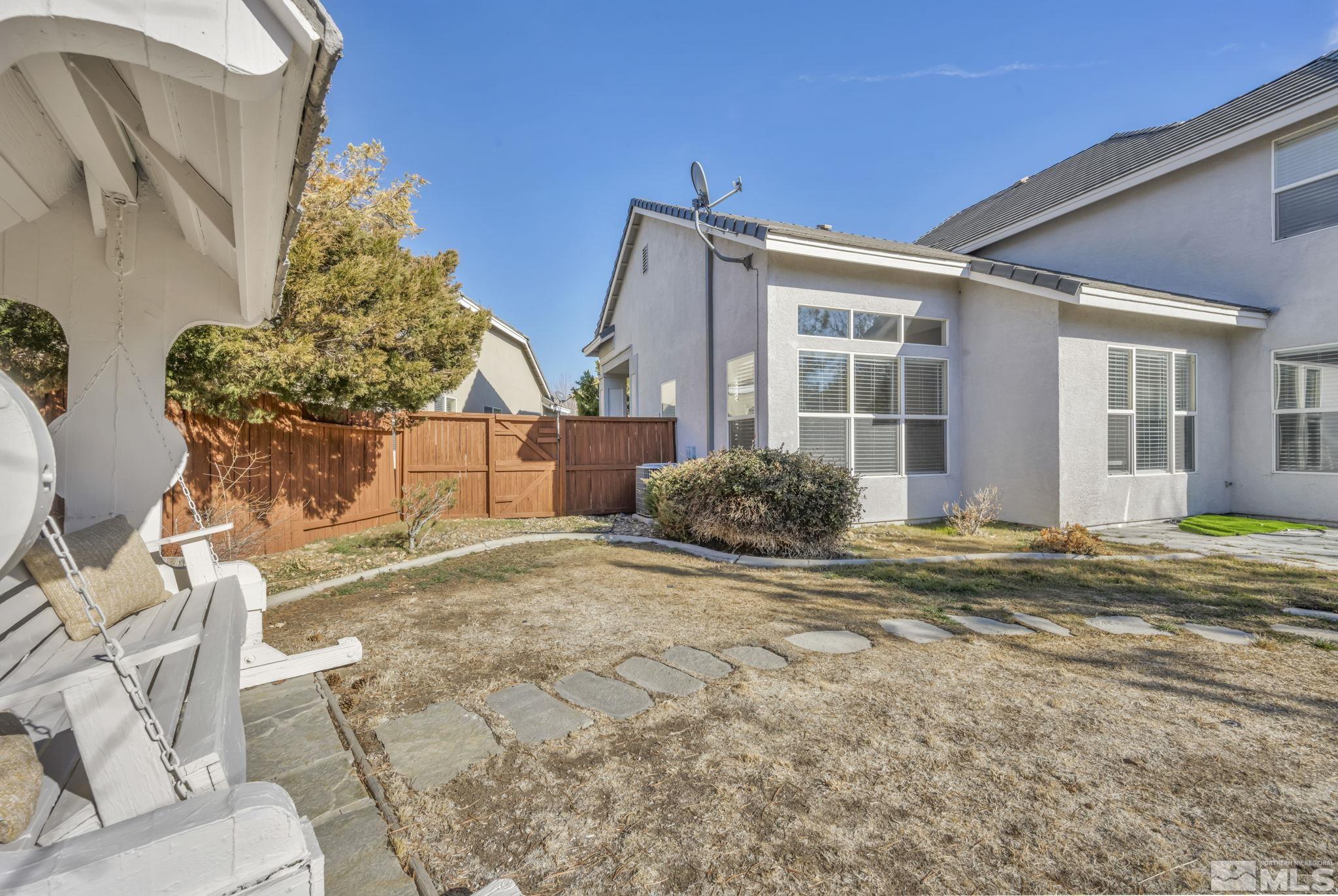 9765 Rolling Rock Court Reno, NV 89521 - Photo 35 of 39 a view of a house with backyard and sitting area