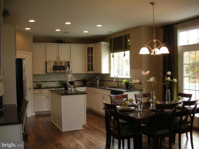 4231 Forge Road Perry Hall, MD 21128 - Photo 4 of 10 a kitchen with a dining table chairs and refrigerator