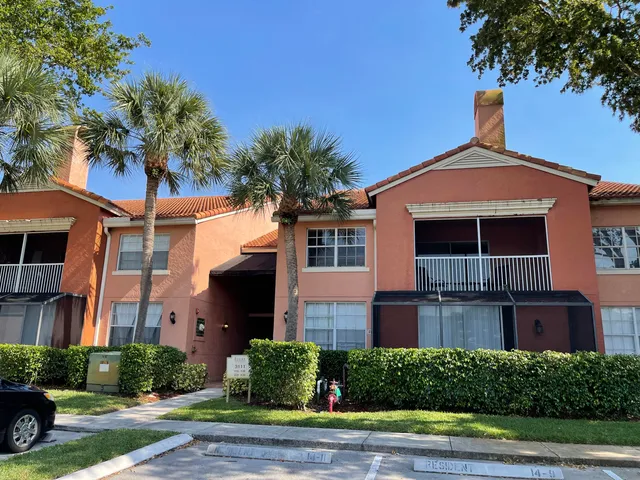 a view of multiple houses with palm trees