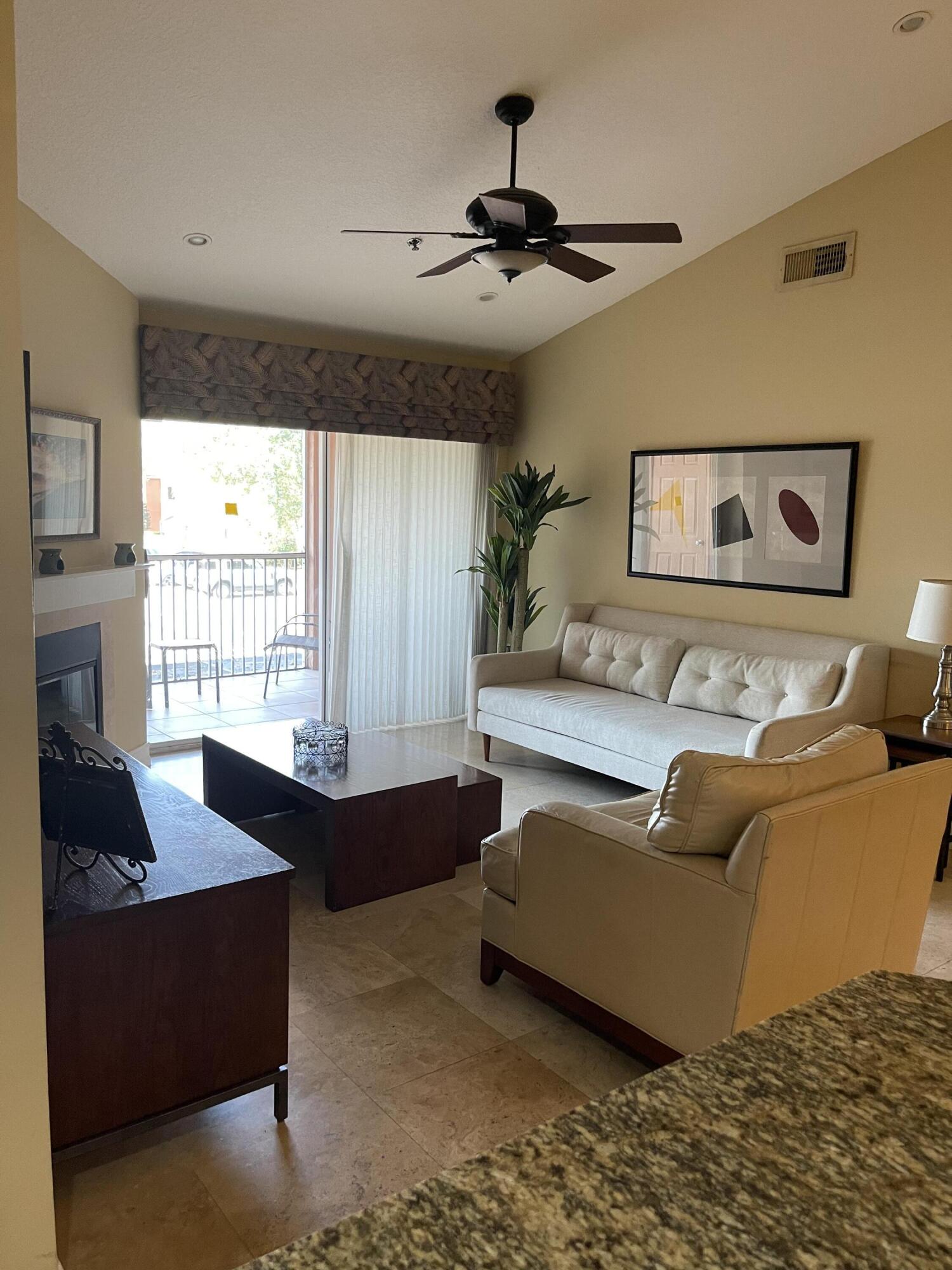 3111 Clint Moore Road, Unit 205 Boca Raton, FL 33496 - Photo 17 of 35 a living room with furniture and large windows