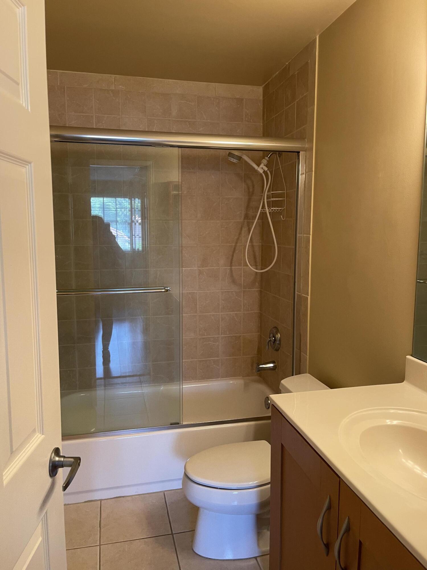 3111 Clint Moore Road, Unit 205 Boca Raton, FL 33496 - Photo 18 of 35 a bathroom with a granite countertop bathtub shower and toilet