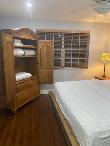 a living room with furniture a large window and table