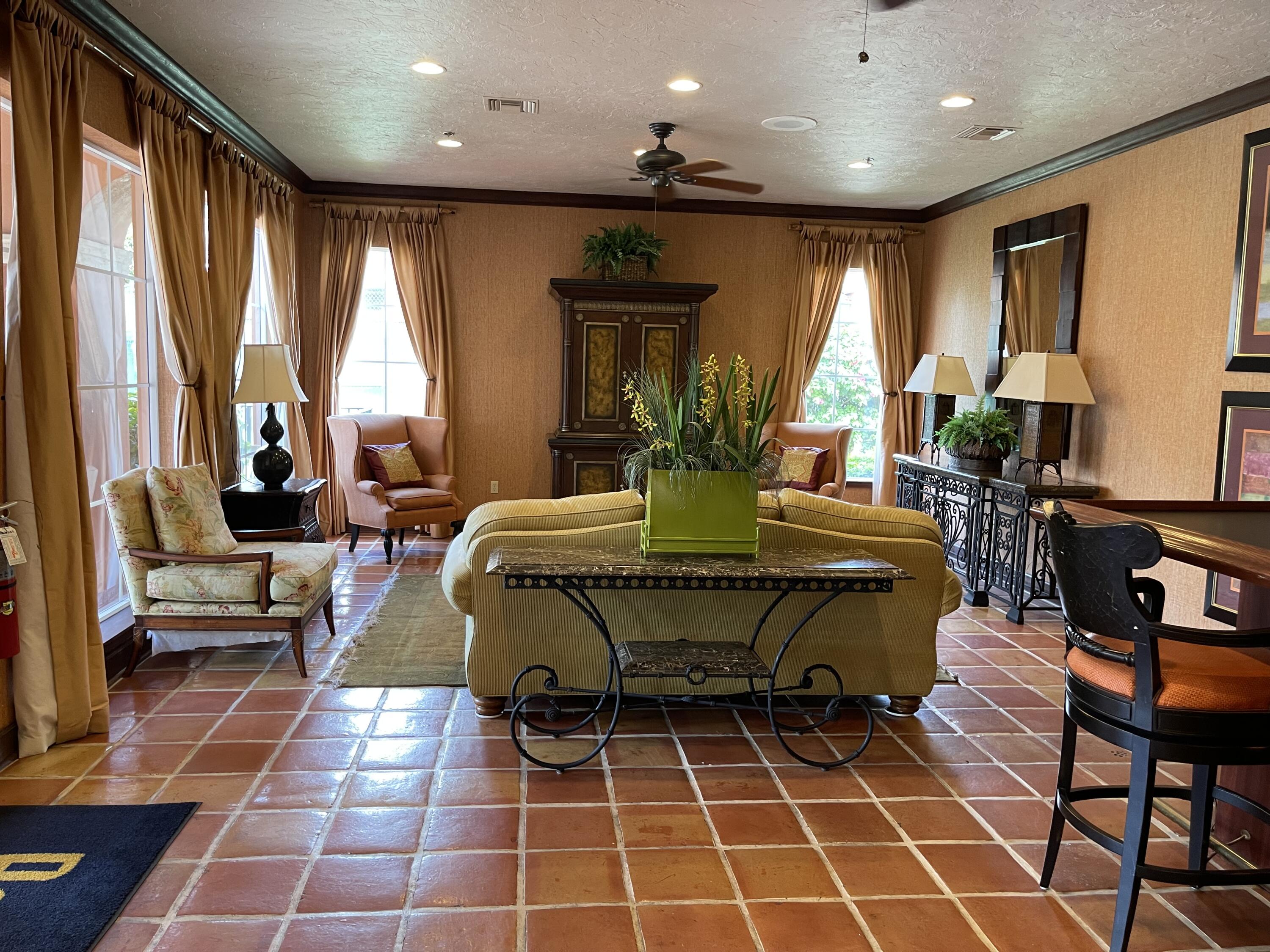 3111 Clint Moore Road, Unit 205 Boca Raton, FL 33496 - Photo 30 of 35 a living room with furniture a large window and table