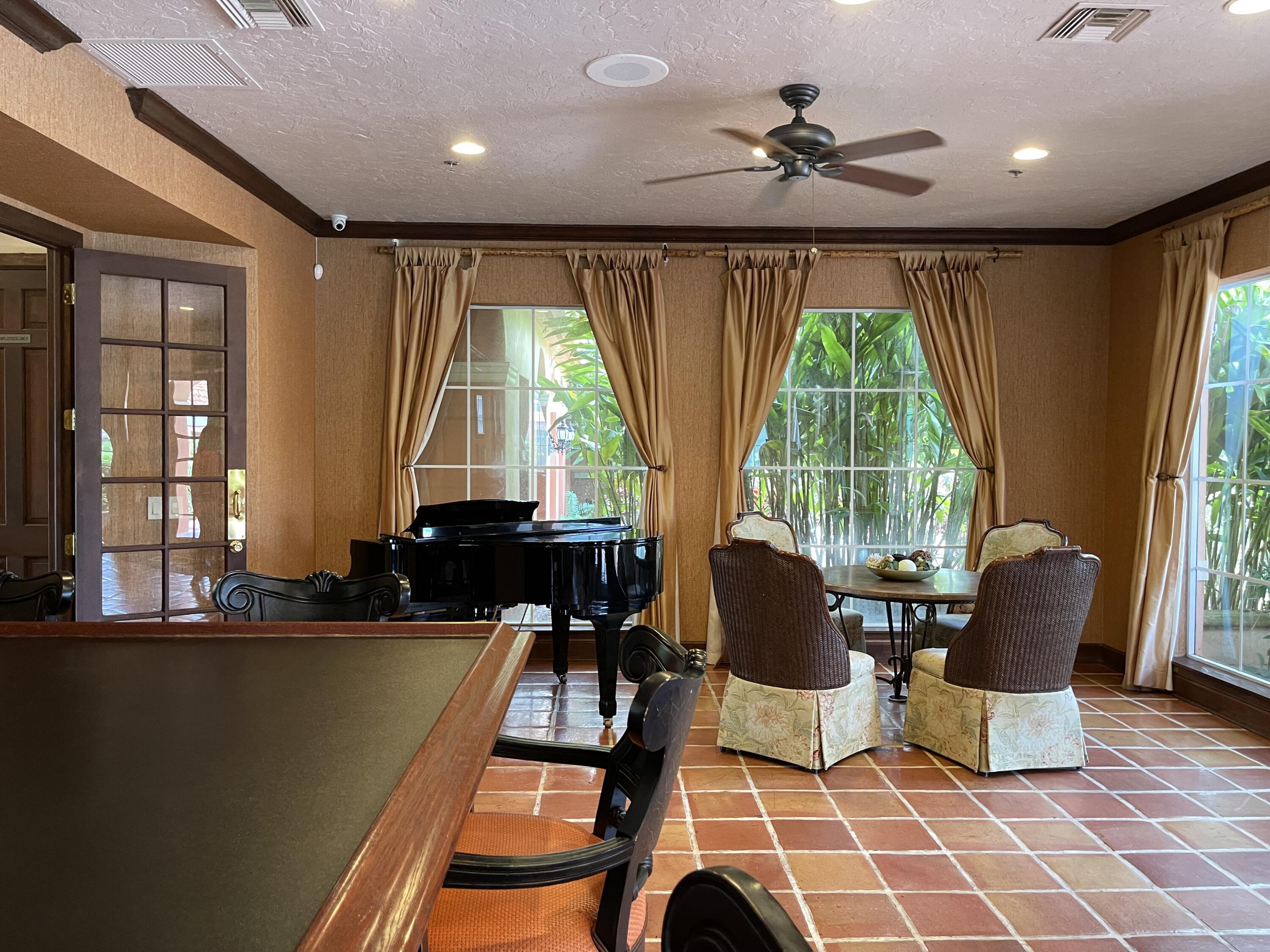 3111 Clint Moore Road, Unit 205 Boca Raton, FL 33496 - Photo 32 of 35 a living room with furniture and a large window