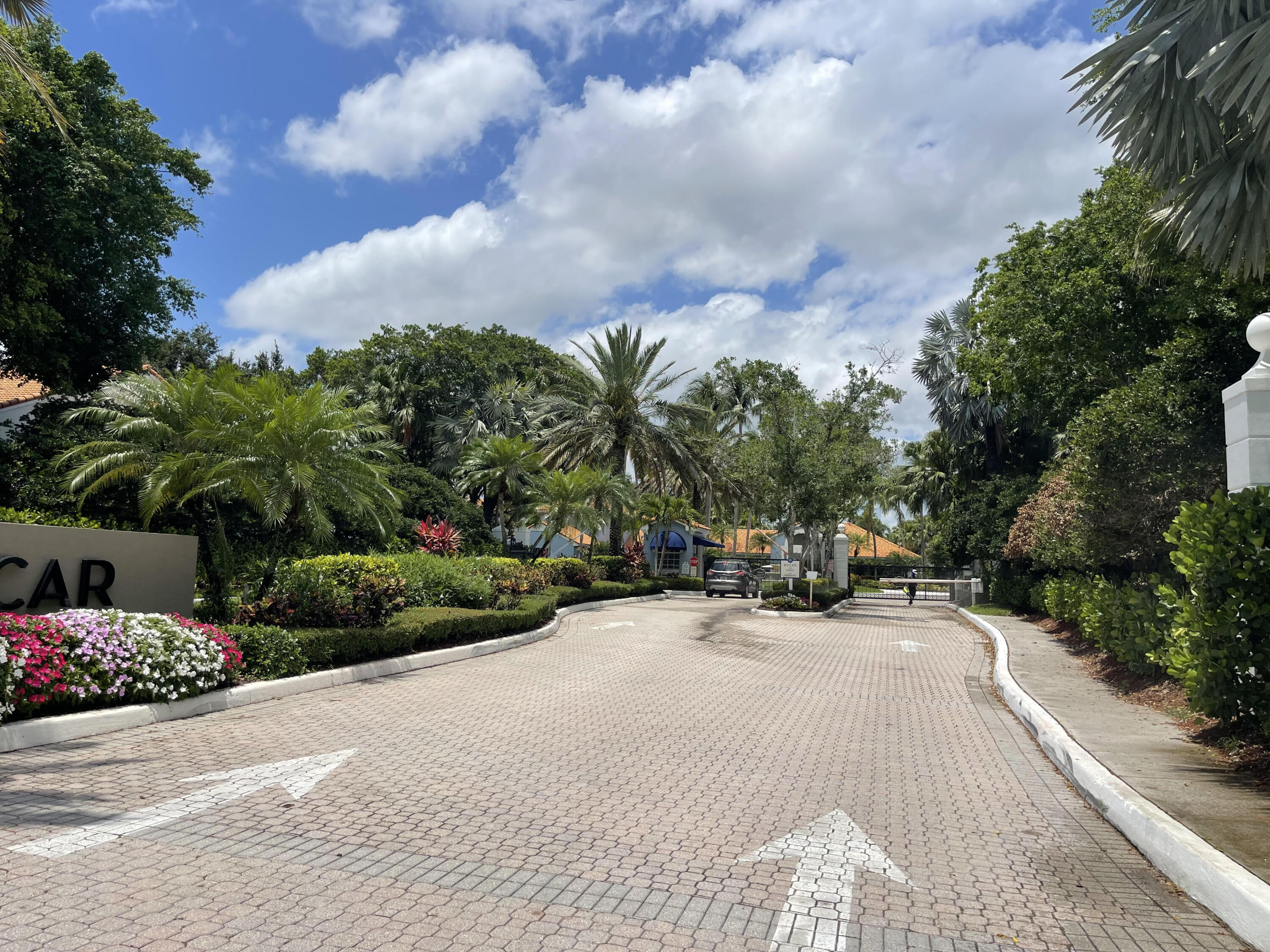 3111 Clint Moore Road, Unit 205 Boca Raton, FL 33496 - Photo 35 of 35 a view of a street with a bench and trees
