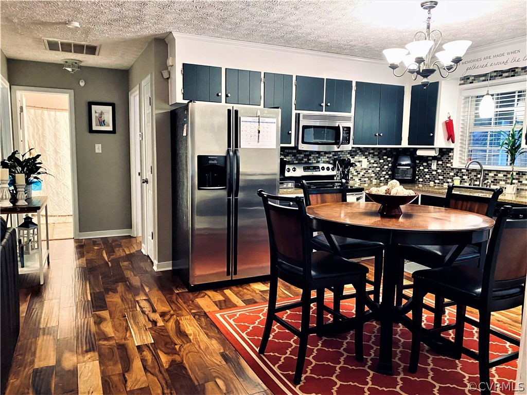 19600 Trumpeter Road Petersburg, VA 23803 - Photo 17 of 33 a kitchen with stainless steel appliances granite countertop a dining table and chairs