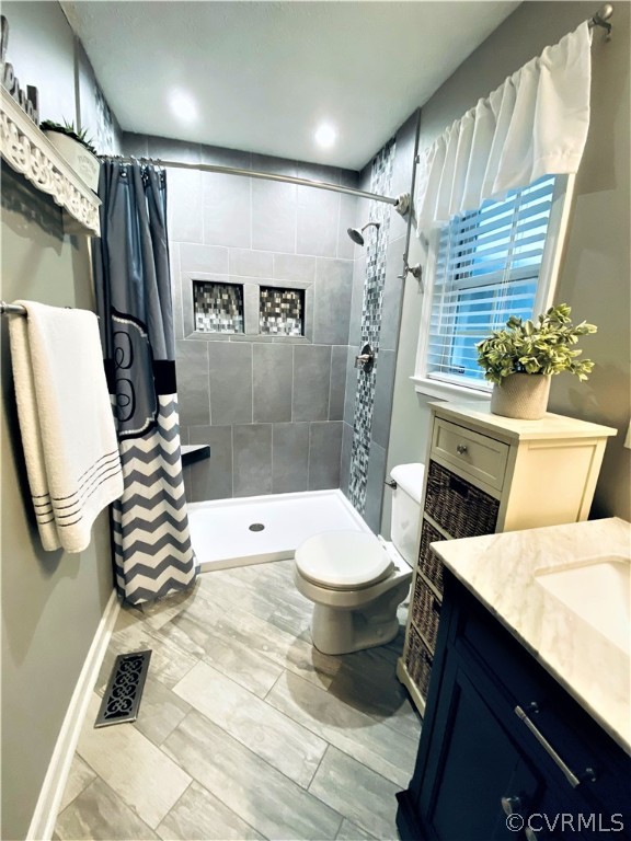 19600 Trumpeter Road Petersburg, VA 23803 - Photo 25 of 33 a bathroom with a sink a toilet a mirror and shower