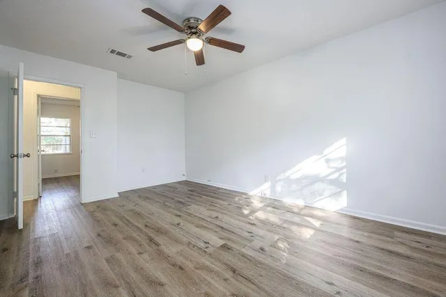 wooden floor in an empty room with a window