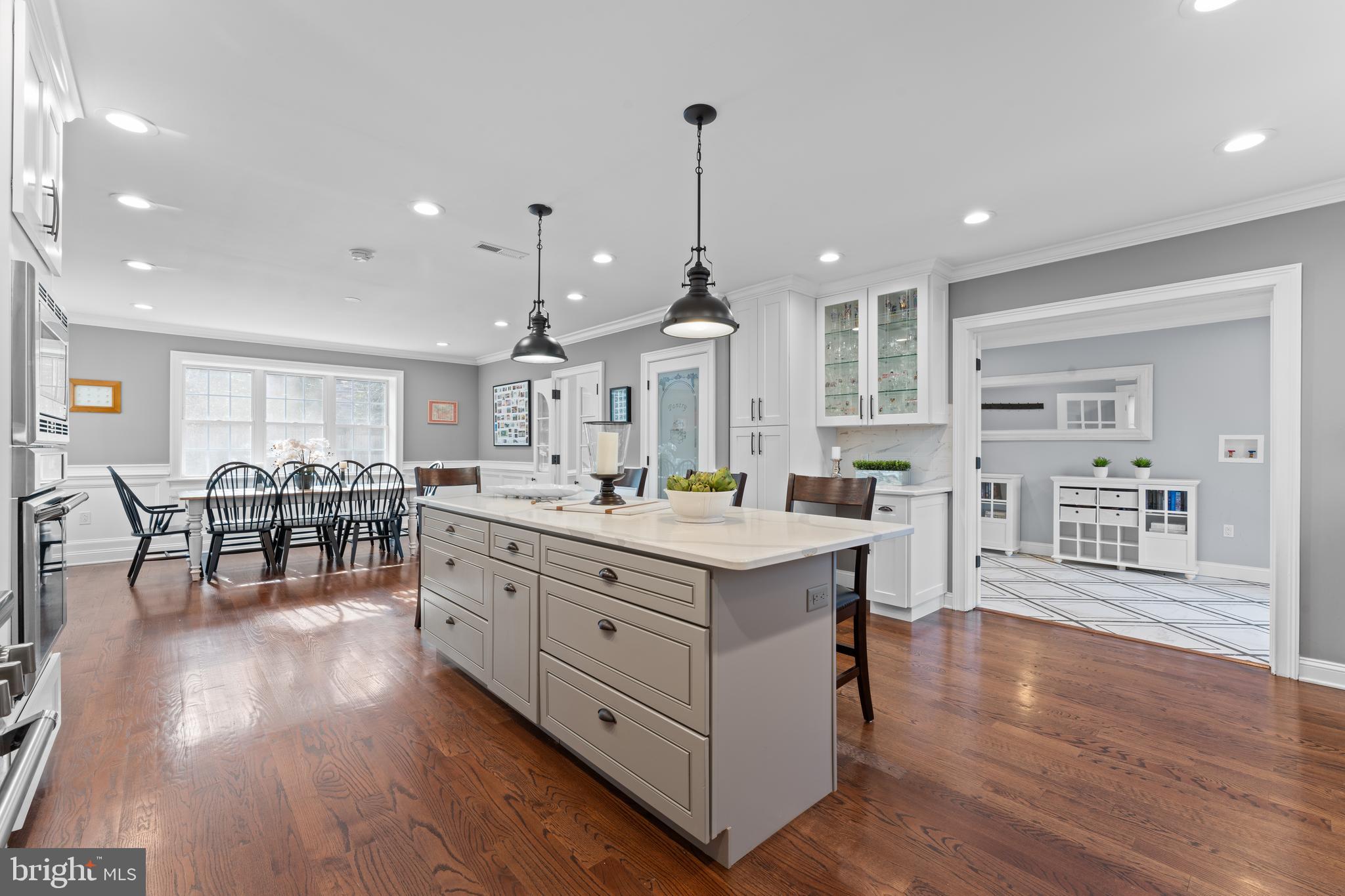 a large kitchen with lots of counter space and a wooden floor