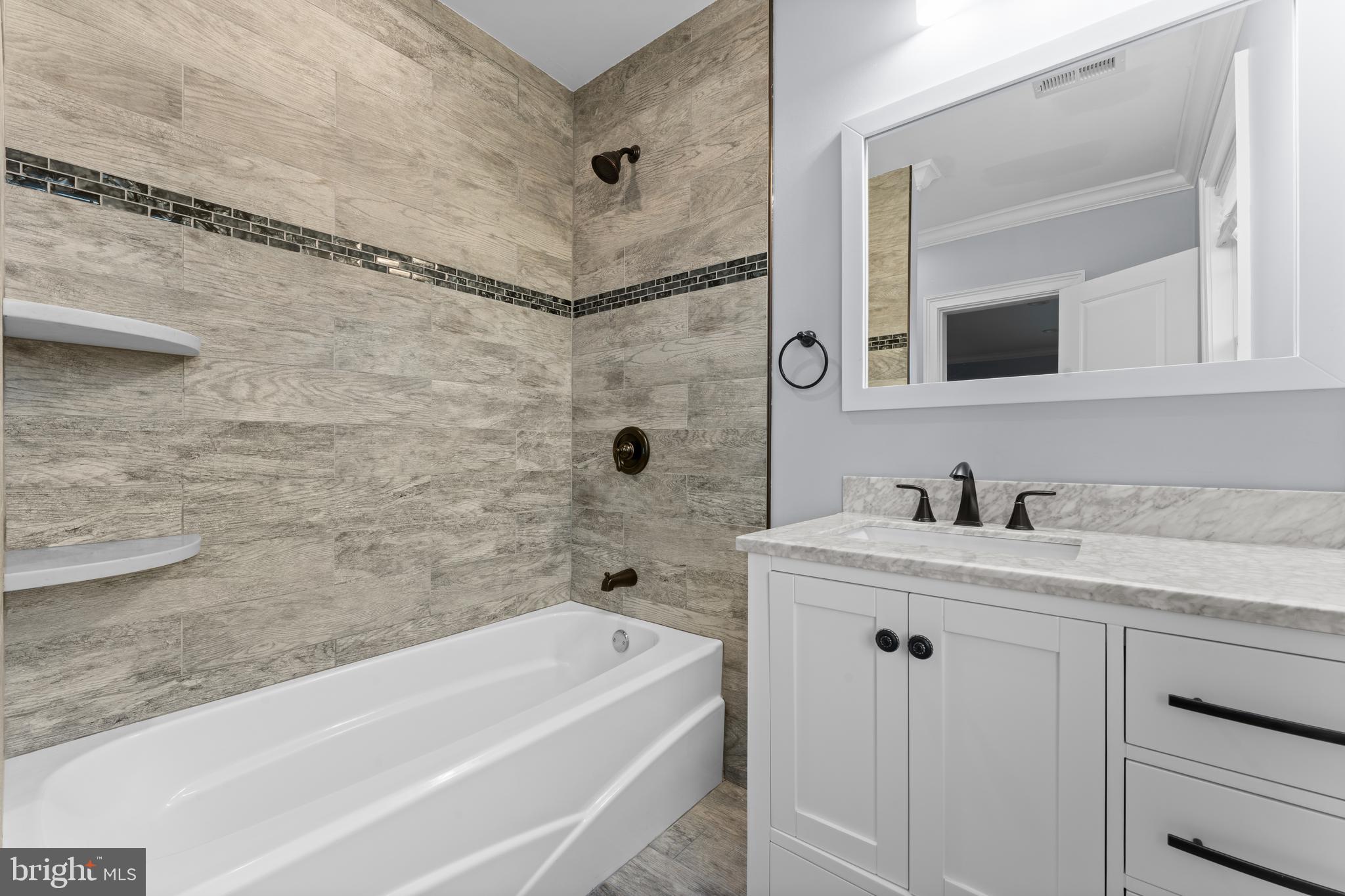 334 Fairhill Road Wynnewood, PA 19096 - Photo 26 of 45 a bathroom with a granite countertop bathtub sink vanity and mirror