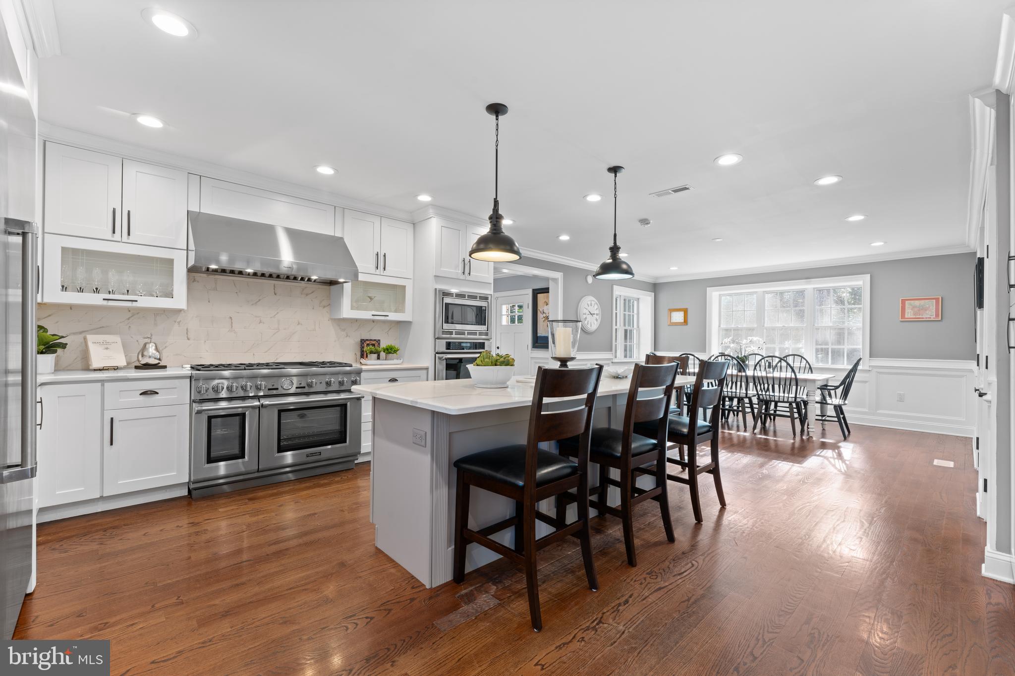 334 Fairhill Road Wynnewood, PA 19096 - Photo 5 of 45 a kitchen with stainless steel appliances granite countertop wooden floor a stove a sink a dining table and chairs