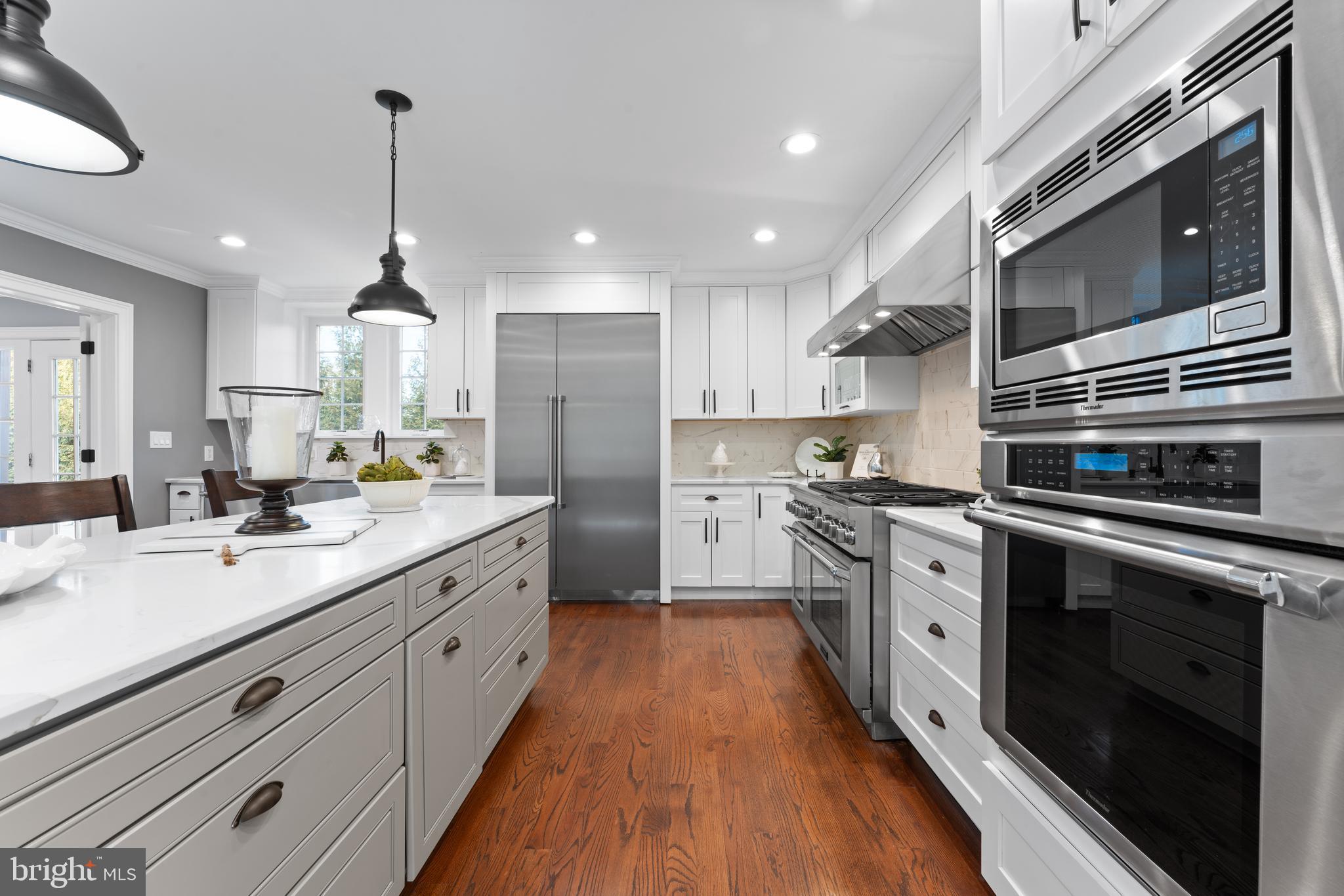 334 Fairhill Road Wynnewood, PA 19096 - Photo 7 of 45 a kitchen with stainless steel appliances kitchen island granite countertop a sink a stove top oven and cabinets