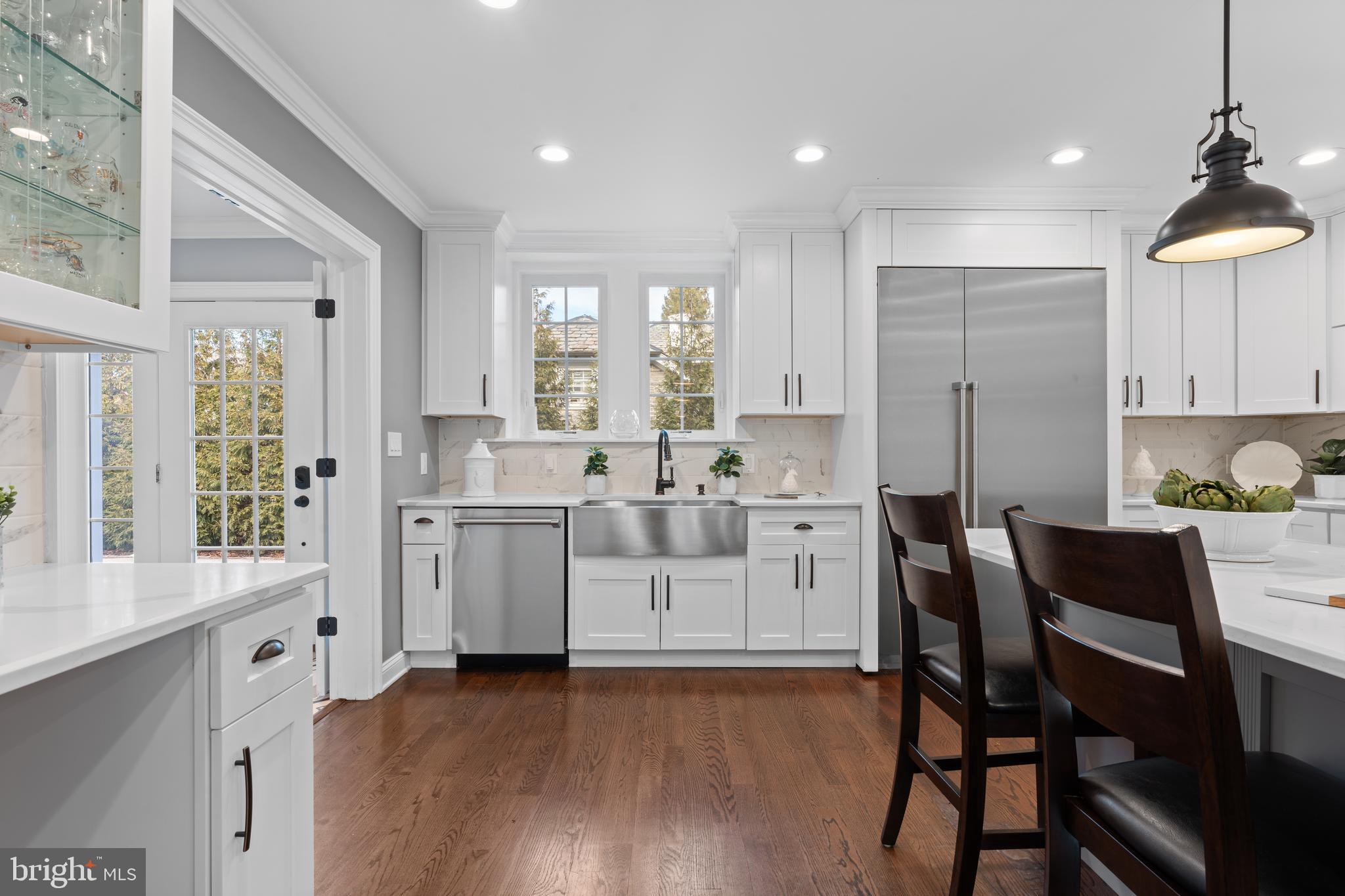 334 Fairhill Road Wynnewood, PA 19096 - Photo 8 of 45 a large white kitchen with white cabinets and wooden floor