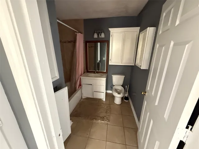 a bathroom with a sink a toilet and a shower a mirror