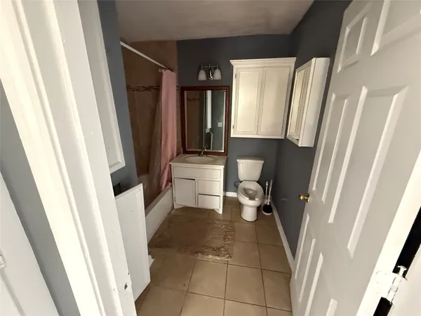a bathroom with a sink a toilet and a shower a mirror