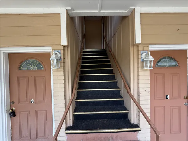 a view of entryway with wooden floor and stairs