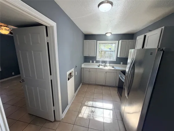 a kitchen with stainless steel appliances a refrigerator and a sink