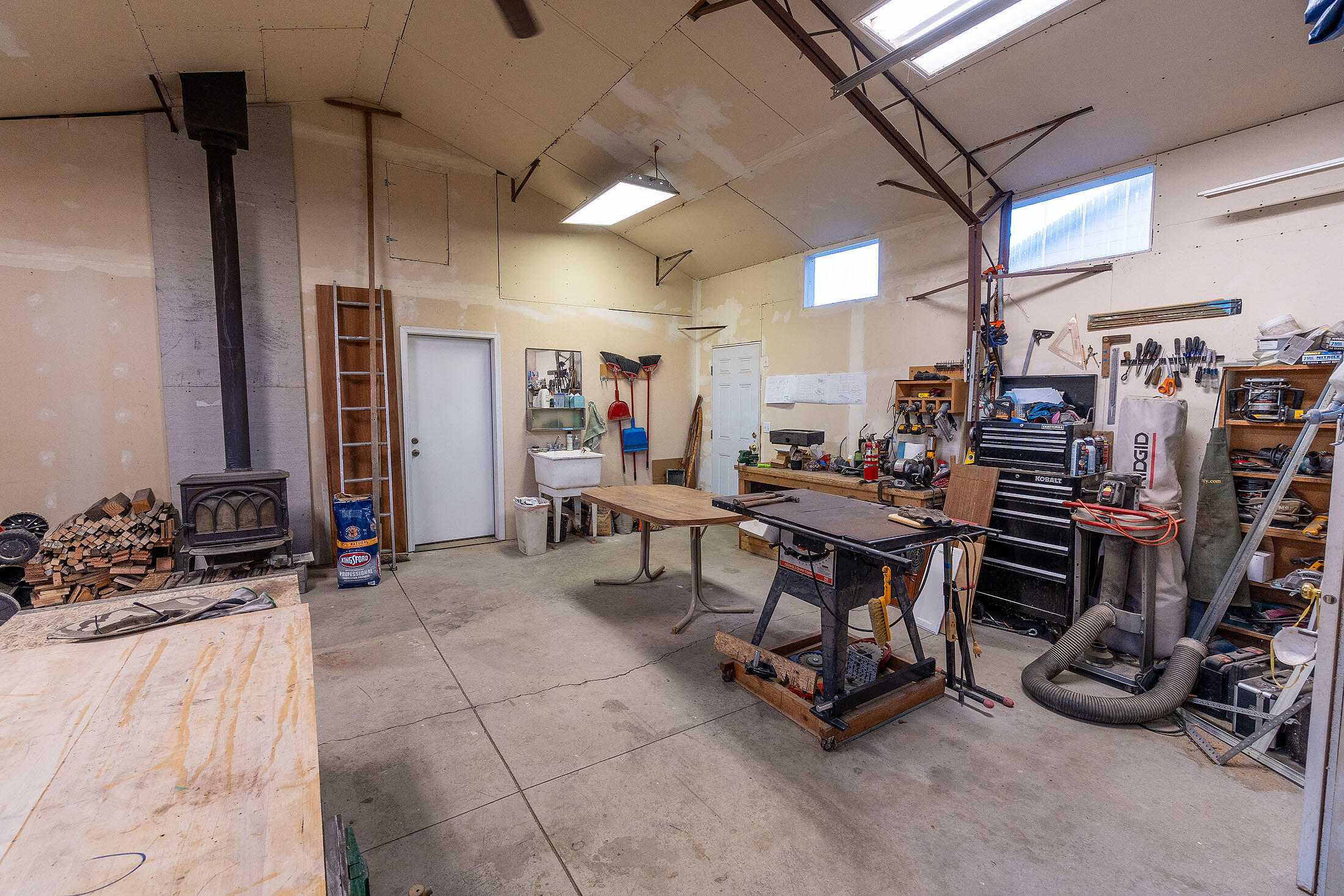 411 Northwest Mc Donald Road Prineville, OR 97754 - Photo 23 of 47 Shop has sheetrock and insulation, pressure tank room, permitted wood stove and entry to the office/apartment.