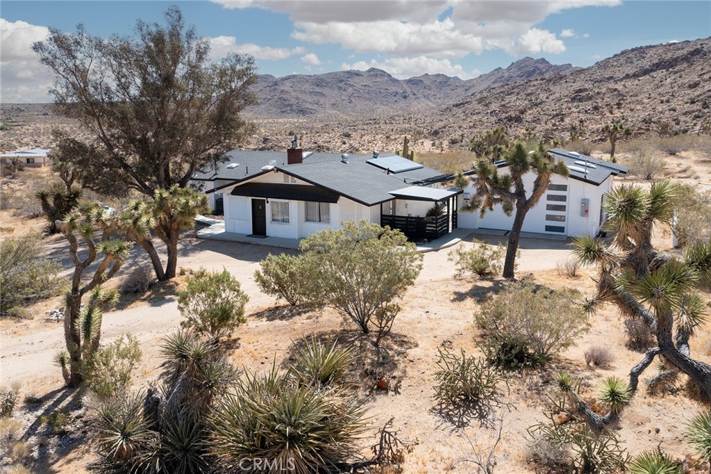 9073 Tortuga Trail Joshua Tree, CA 92252 - Photo 1 of 39 a view of a house with a yard covered in snow
