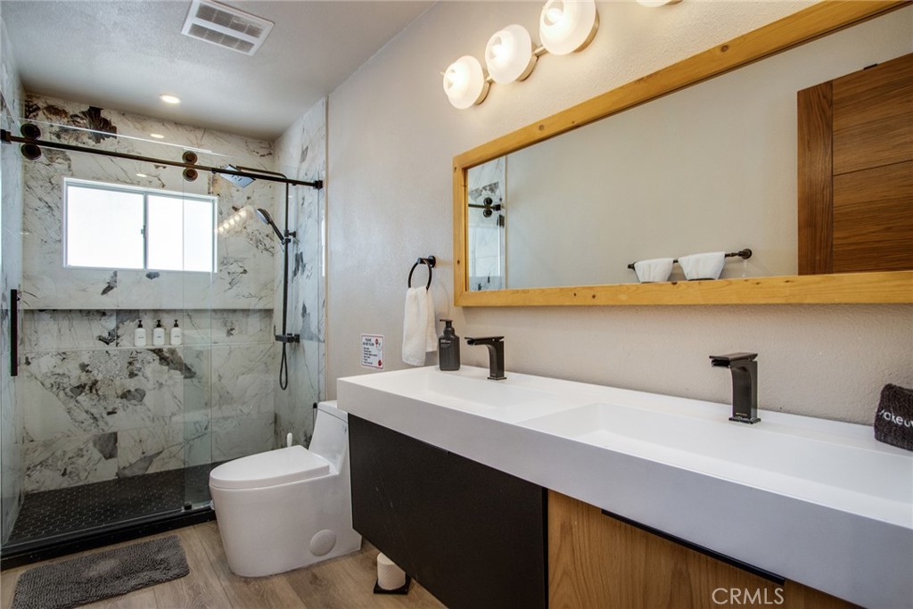 9073 Tortuga Trail Joshua Tree, CA 92252 - Photo 13 of 39 a bathroom with a sink a toilet and a mirror