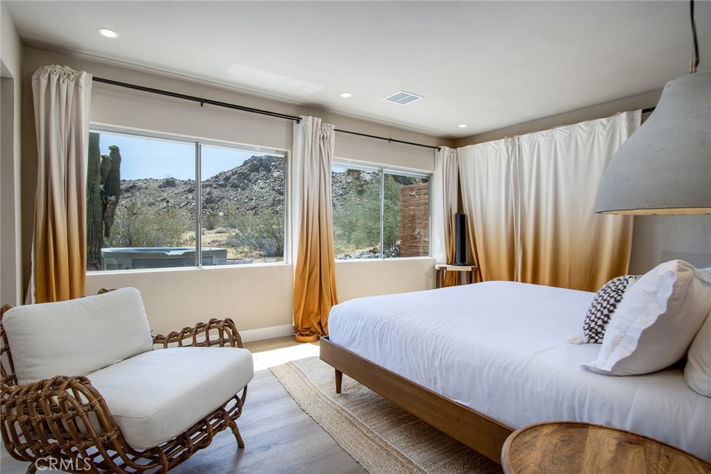 9073 Tortuga Trail Joshua Tree, CA 92252 - Photo 16 of 39 a bedroom with a bed and a couch