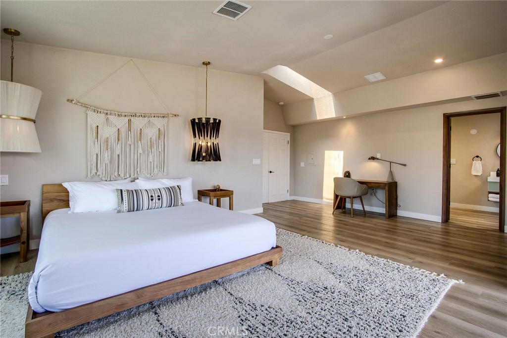 9073 Tortuga Trail Joshua Tree, CA 92252 - Photo 19 of 39 a bedroom with furniture and wooden floor
