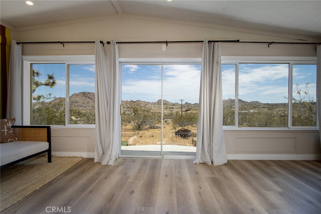 9073 Tortuga Trail Joshua Tree, CA 92252 - Photo 23 of 39 a view of an empty room with wooden floor and a window